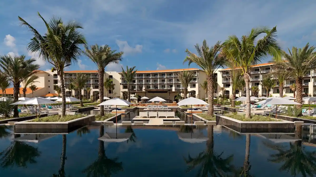 Infinity pool at UNICO 20°105° Hotel Vallarta with oceanview suites in the background and the Pacific coastline beyond